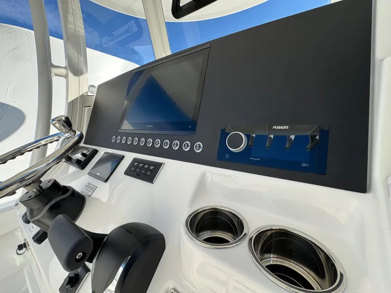 Slide: The Image of 2025 Regulator 26XO boat dashboard with steering wheel and control panel. - 13