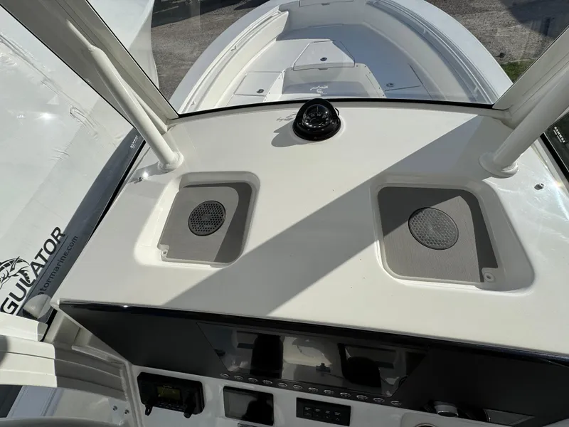 Slide: The Image of 2025 Regulator 26XO boat dashboard with speakers and compass. - 14