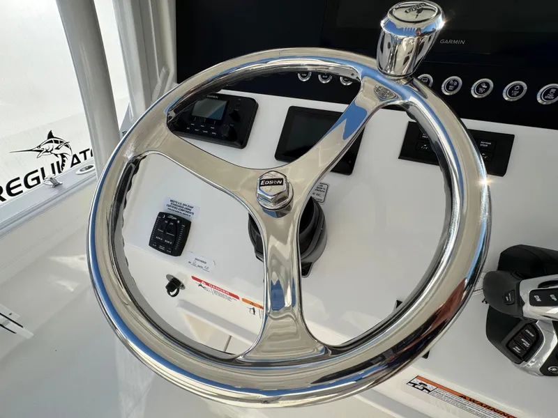 Slide: The Image of Steering wheel of 2025 Regulator 26XO boat, featuring modern controls and sleek design. - 17