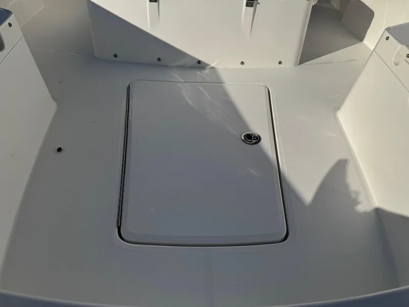 Slide: The Image of 2025 Regulator 26XO boat deck with storage hatch, white finish. - 19