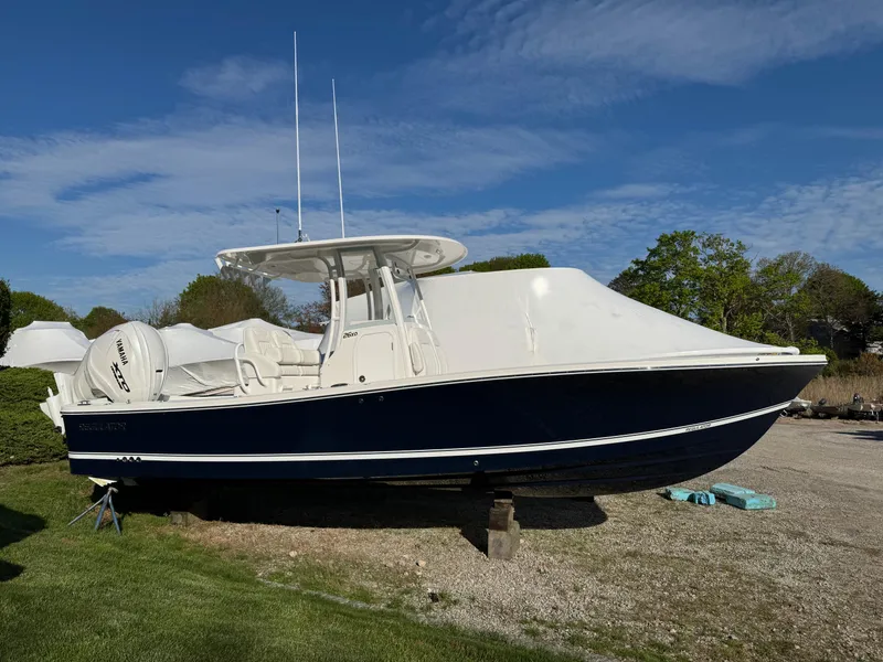 Slide: The Image of 2025 Regulator 26XO boat on display outdoors, featuring sleek design and modern features. - 2