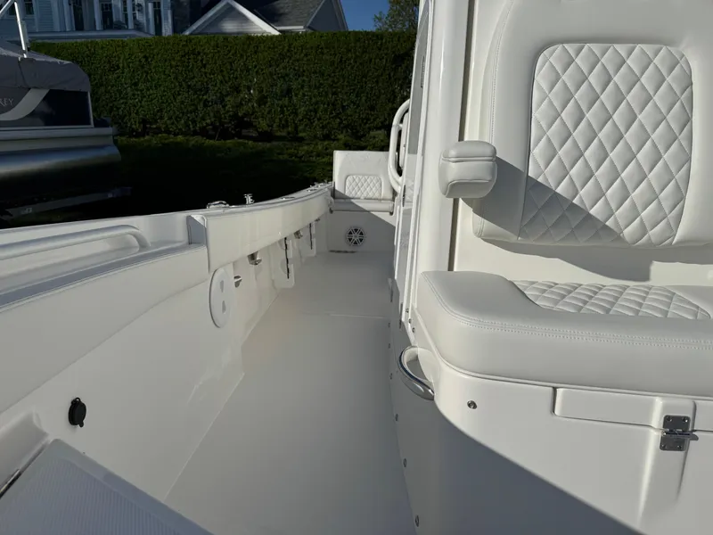 Slide: The Image of 2025 Regulator 26XO boat interior with white quilted seating and sleek design. - 21