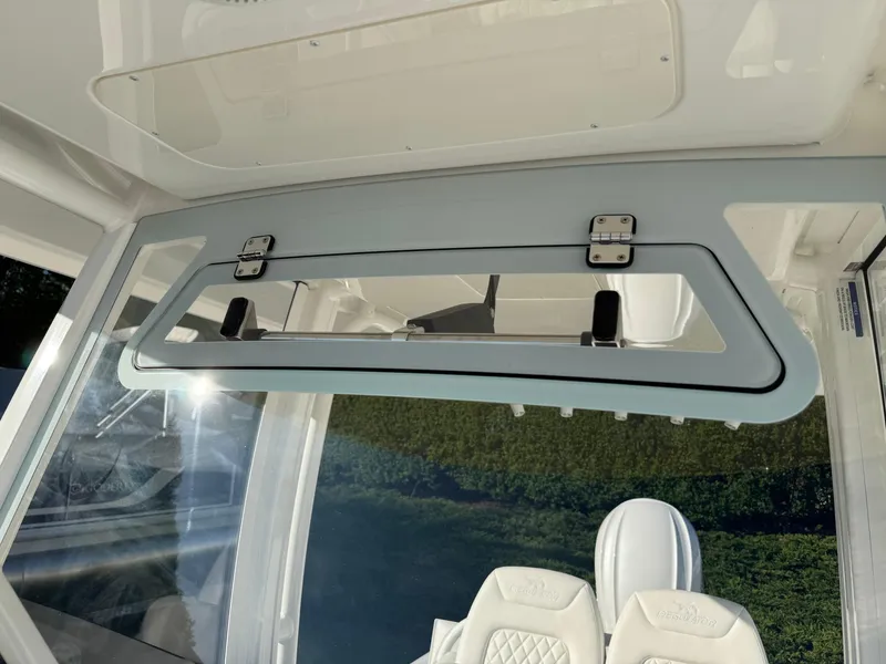 Slide: The Image of 2025 Regulator 26XO boat interior with modern seating and window design. - 24