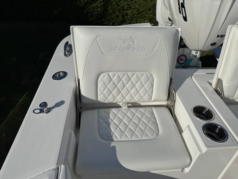 Slide: The Image of 2025 Regulator 26XO boat seat with diamond stitching and cup holders. - 28