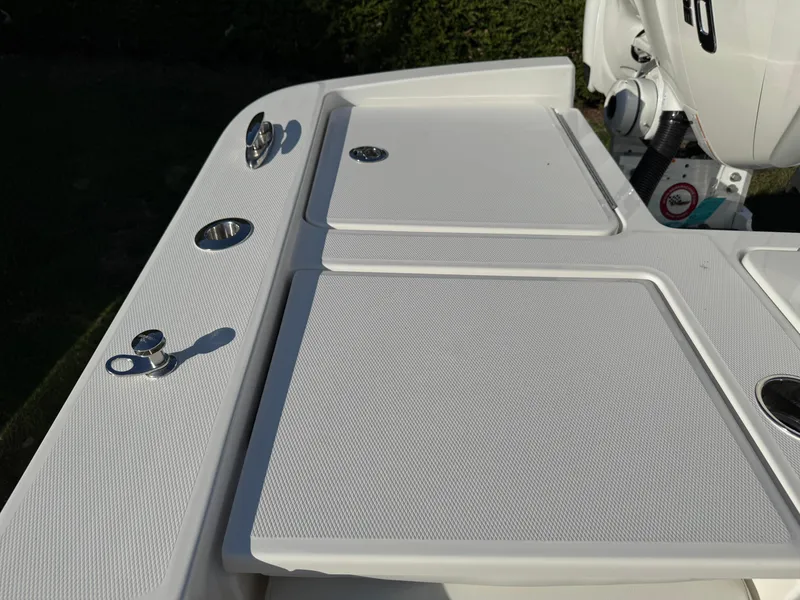 Slide: The Image of 2025 Regulator 26XO boat deck with storage compartments and sleek design. - 29