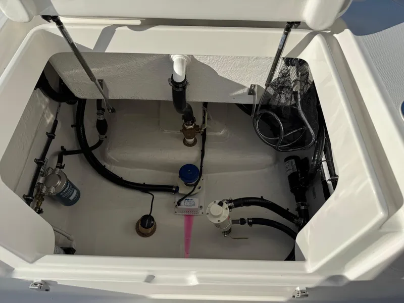 Slide: The Image of 2025 Regulator 26XO boat compartment showcasing internal plumbing and storage features. - 31