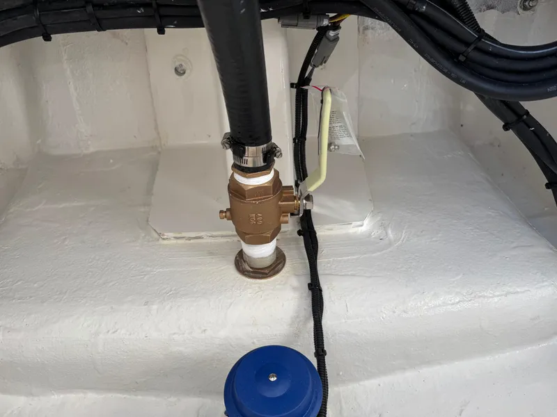 Slide: The Image of Boat plumbing system in 2025 Regulator 26XO, featuring a brass valve and connected hoses. - 32