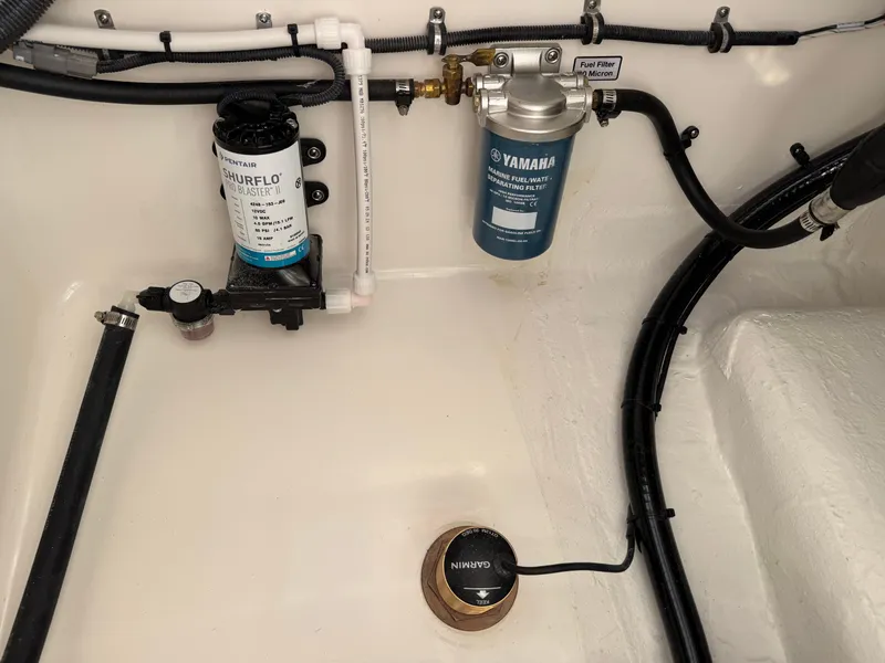 Slide: The Image of 2025 Regulator 26XO boat engine compartment with Yamaha and Shurflo components. - 33