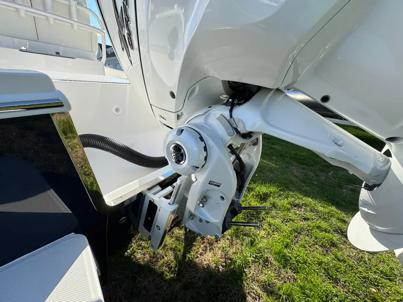 Slide: The Image of 2025 Regulator 26XO boat engine detail on grassy surface. - 6