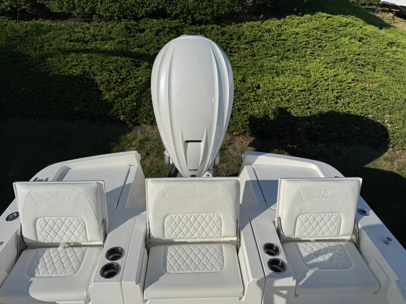 Slide: The Image of 2025 Regulator 26XO boat with white seating and engine, viewed from above. - 8