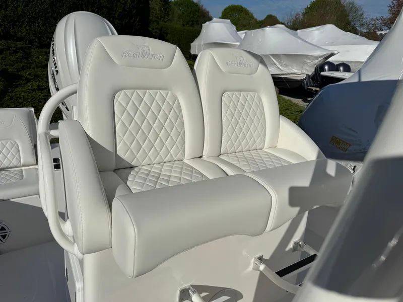 Slide: The Image of 2025 Regulator 26XO boat with white quilted seating, showcasing luxury and comfort. - 9