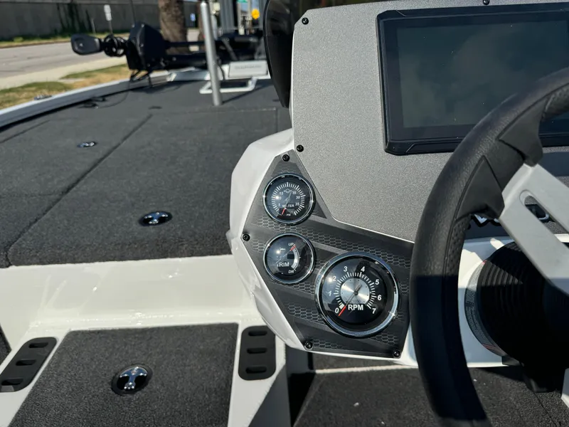 Slide: The Image of 2025 Vexus AVX 1880 boat dashboard with gauges and steering wheel. - 11