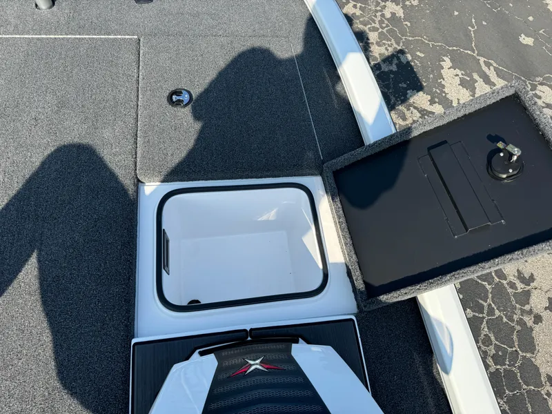 Slide: The Image of 2025 Vexus AVX 1880 boat storage compartment with open lid, showing interior details. - 26