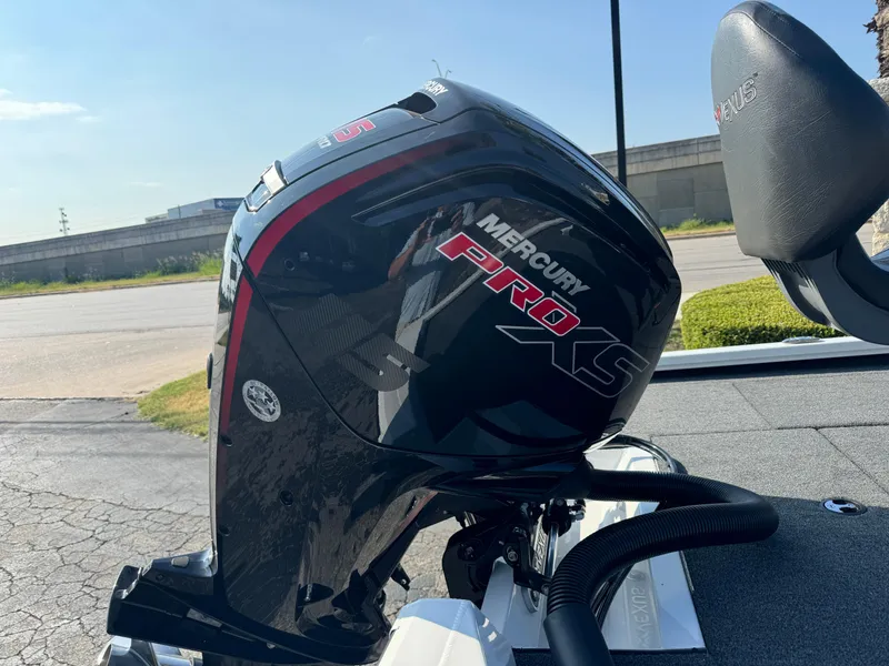 Slide: The Image of 2025 Vexus AVX 1880 with Mercury Pro XS outboard motor, parked outdoors. - 3