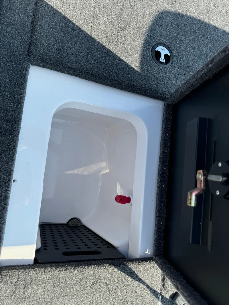 Slide: The Image of 2025 Vexus AVX 1880 boat storage compartment with carpeted interior and latch. - 37
