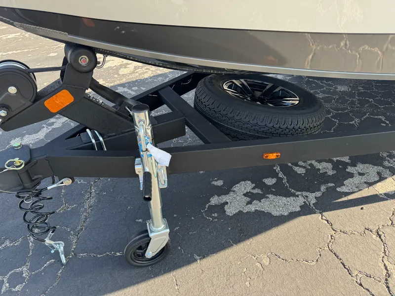 Slide: The Image of 2025 Vexus AVX 1880 boat trailer with spare tire on asphalt. - 7