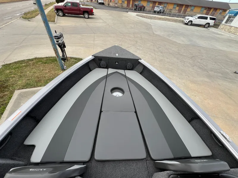 Slide: The Image of 2025 Lund 2075 IMPACT XS boat interior with sleek seating and storage compartments. - 11