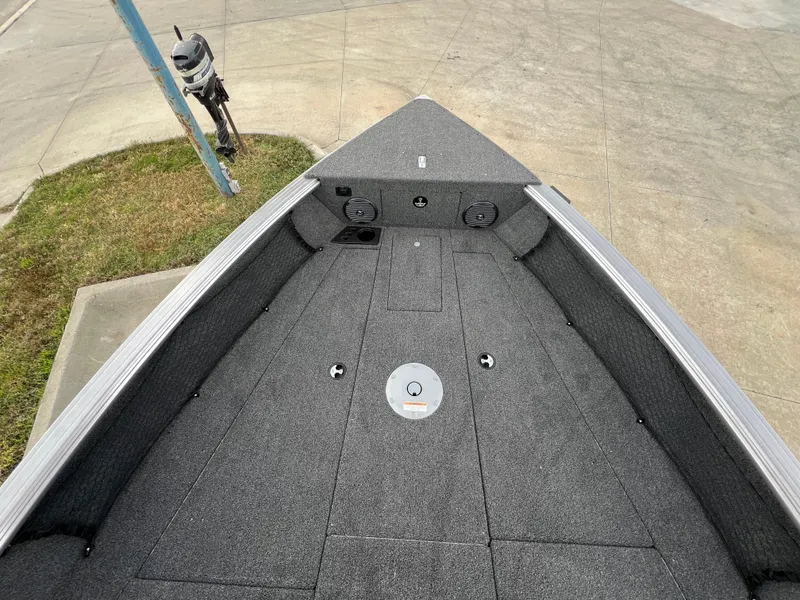 Slide: The Image of 2025 Lund 2075 IMPACT XS boat deck, gray finish, outdoor setting. - 15