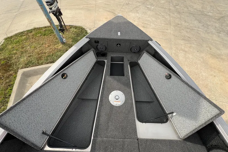 Slide: The Image of 2025 Lund 2075 IMPACT XS boat with open storage compartments on deck. - 17