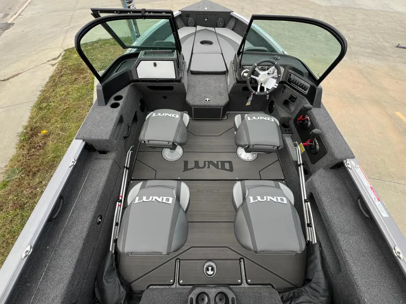 Slide: The Image of 2025 Lund 2075 IMPACT XS boat interior with four seats and steering console. - 4