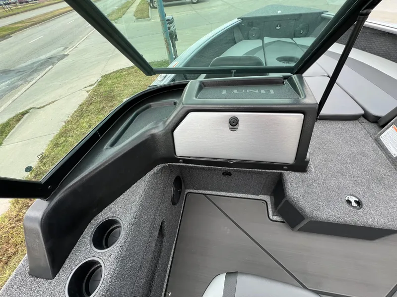 Slide: The Image of 2025 Lund 2075 IMPACT XS boat interior with storage and cup holders. - 5