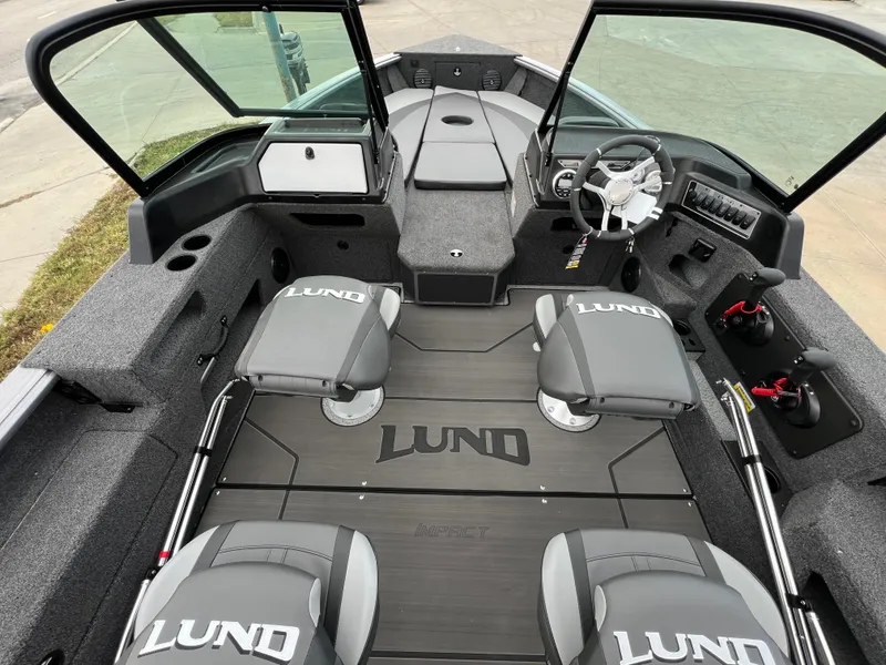 Slide: The Image of 2025 Lund 2075 IMPACT XS boat interior with seating and steering console. - 6