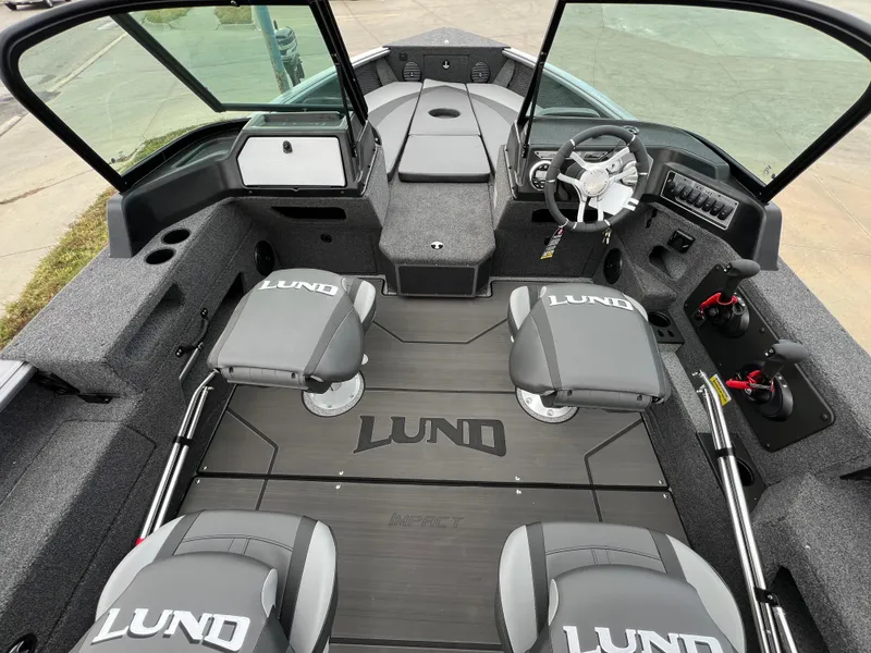 Slide: The Image of 2025 Lund 2075 IMPACT XS boat interior with four seats and steering console. - 7