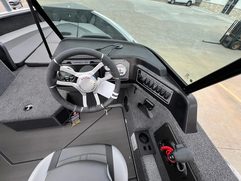Slide: The Image of 2025 Lund 2075 IMPACT XS boat interior with steering wheel and control panel. - 8