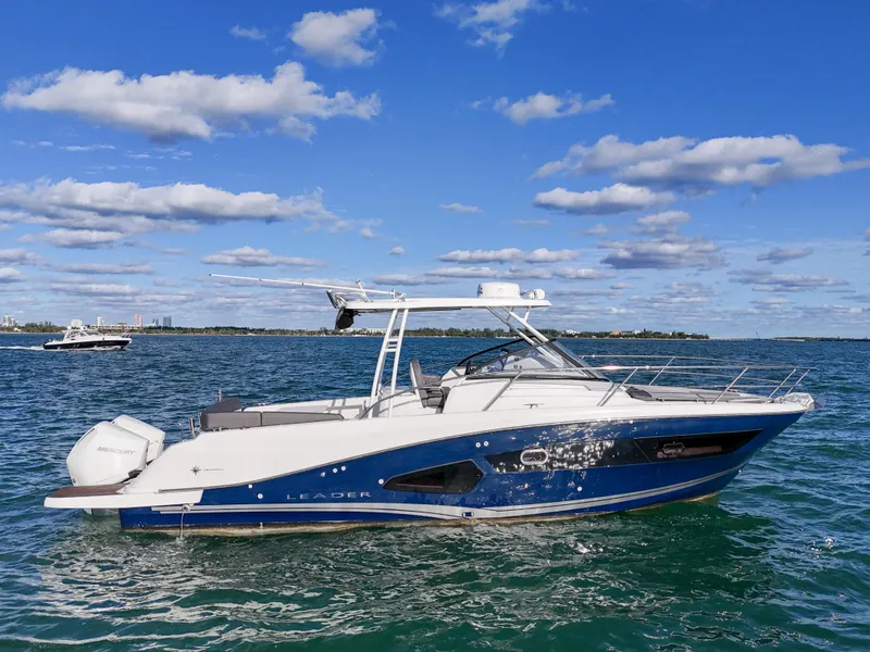 Slide: The Image of 2019 Jeanneau Leader 34 boat on open water under blue sky. - 0