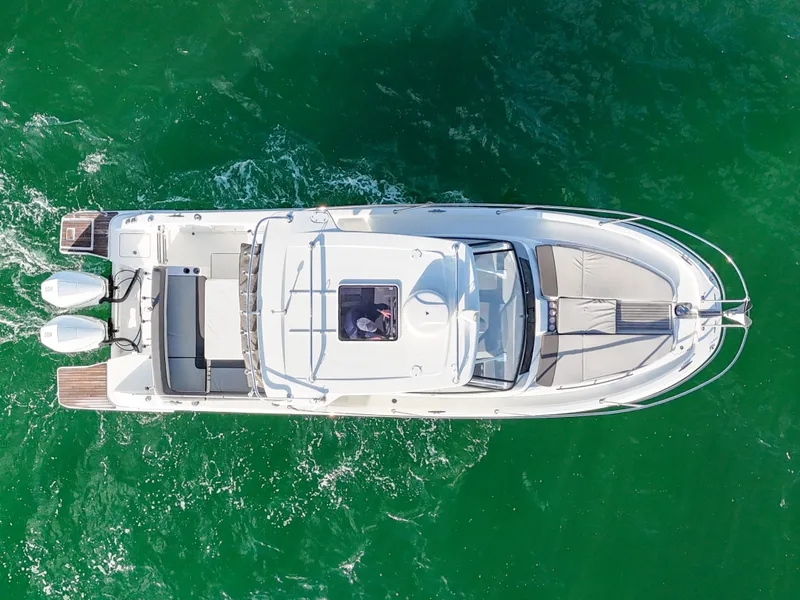 Slide: The Image of Aerial view of 2019 Jeanneau 34 boat cruising on green water. - 13