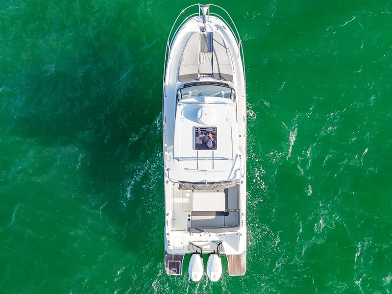 Slide: The Image of Aerial view of 2019 Jeanneau 34 boat on vibrant green water. - 14
