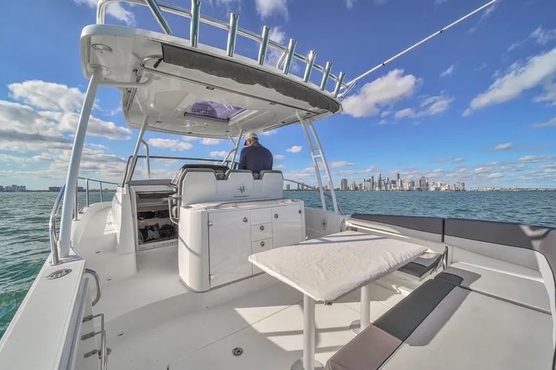 Slide: The Image of 2019 Jeanneau 34 boat on water with city skyline in background. - 22