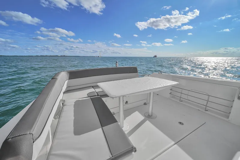 Slide: The Image of 2019 Jeanneau 34 yacht deck with seating, ocean view, and blue sky. - 23