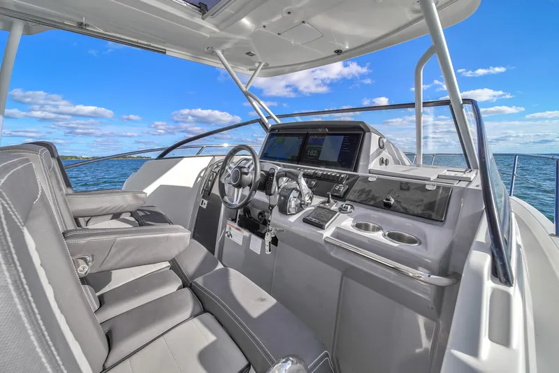 Slide: The Image of 2019 Jeanneau 34 boat cockpit with modern controls and ocean view. - 25