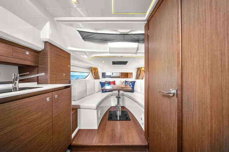 Slide: The Image of Interior of 2019 Jeanneau 34 yacht with modern wood finish and cozy seating area. - 29