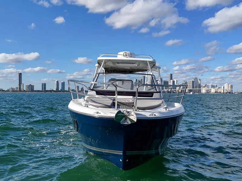 Slide: The Image of 2019 Jeanneau 34 boat on water with city skyline in background. - 3