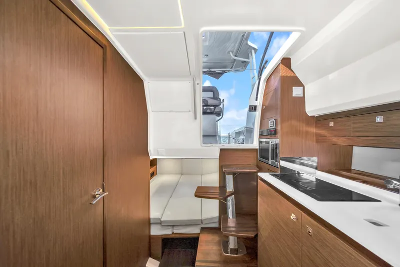 Slide: The Image of Interior of 2019 Jeanneau 34 yacht with modern kitchen and seating area. - 30