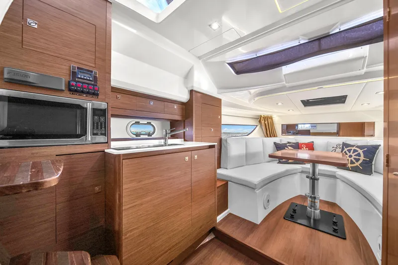 Slide: The Image of Interior of 2019 Jeanneau 34 yacht with modern kitchen and cozy seating area. - 31