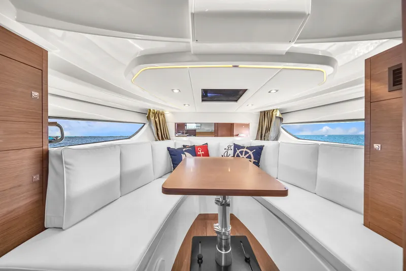 Slide: The Image of Interior of 2019 Jeanneau 34 yacht with elegant seating and ocean view. - 34