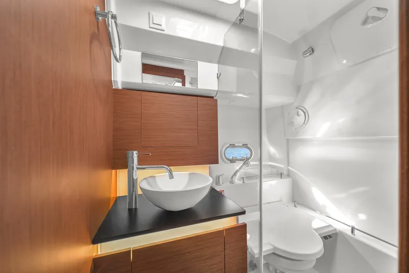 Slide: The Image of Modern bathroom in 2019 Jeanneau 34 yacht with sleek design and wooden cabinetry. - 36