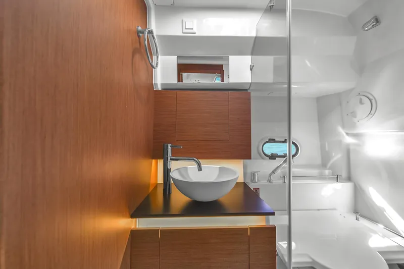 Slide: The Image of Modern bathroom interior of 2019 Jeanneau 34 yacht with sleek wood paneling and round sink. - 37