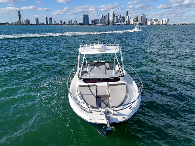 Slide: The Image of 2019 Jeanneau 34 boat cruising near city skyline on sunny day. - 4