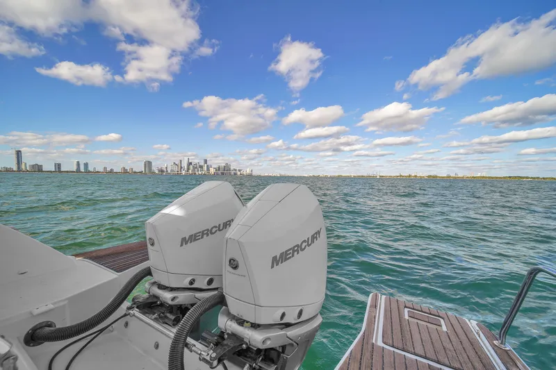 Slide: The Image of Jeanneau 34 boat with Mercury engines on open water, city skyline in background, 2019 model. - 41