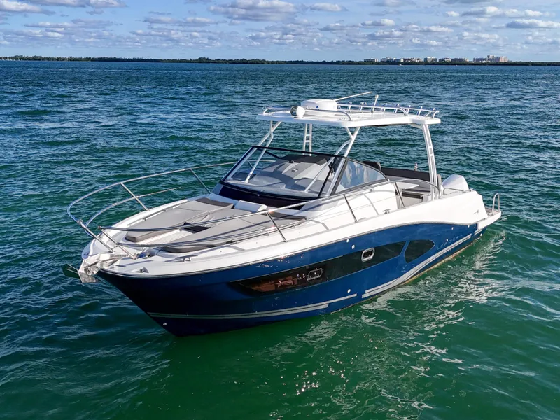 Slide: The Image of 2019 Jeanneau 34 boat on open water under a clear sky. - 5