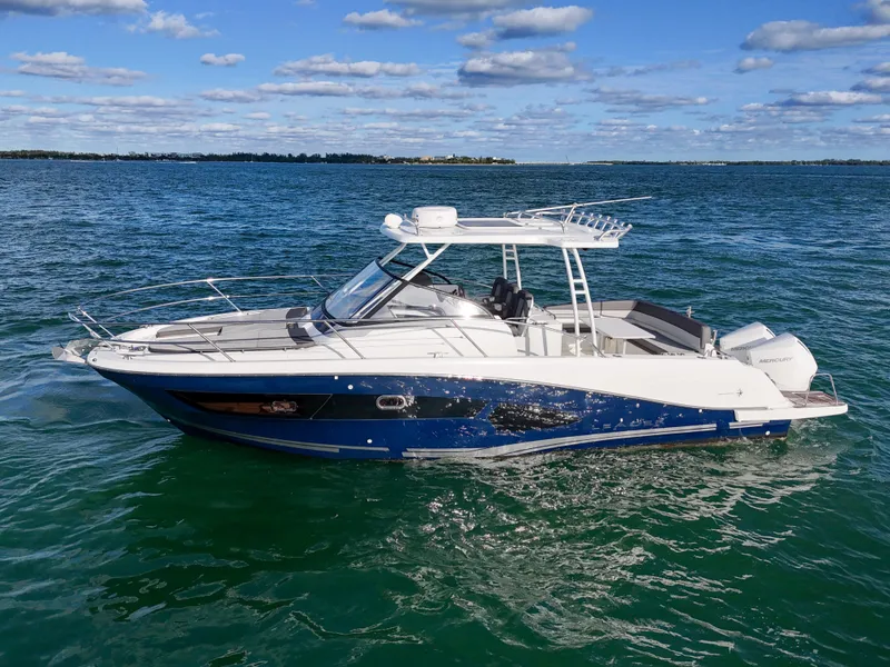Slide: The Image of 2019 Jeanneau 34 boat cruising on open water under a partly cloudy sky. - 6