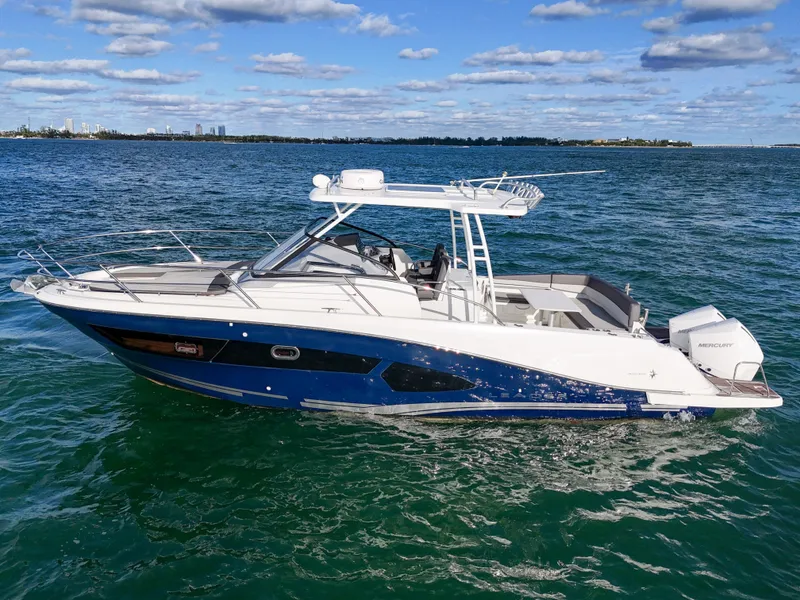 Slide: The Image of 2019 Jeanneau 34 boat cruising on open water under a clear sky. - 7