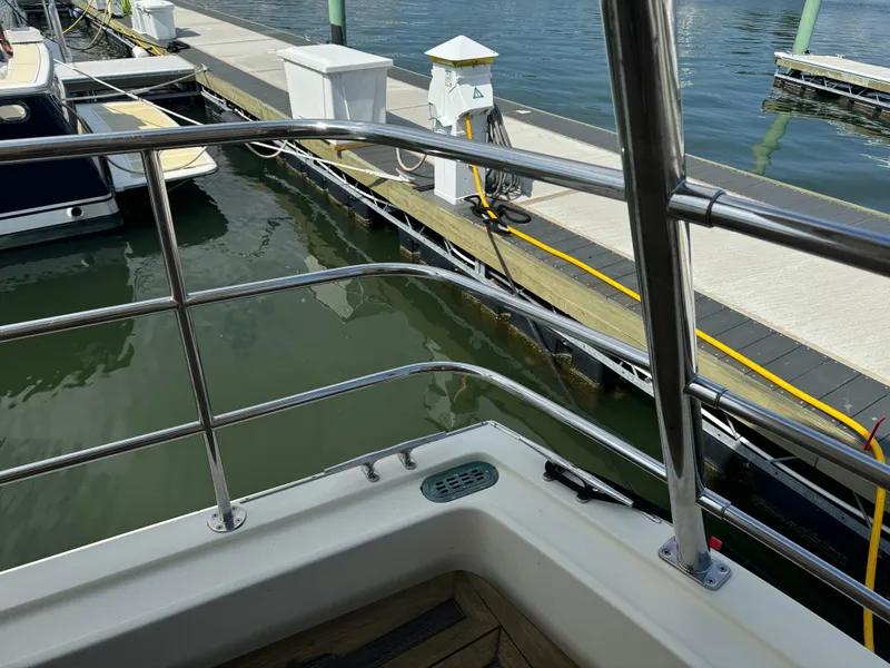 Slide: The Image of 2003 Dettling 51 Express Cruiser docked at marina, viewed from deck railing. - 10