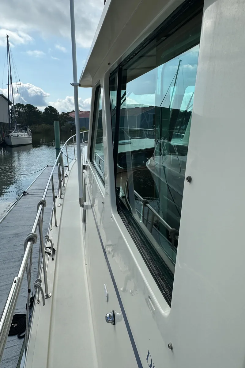 Slide: The Image of 2003 Dettling 51 Express Cruiser docked, side view with windows and railing. - 12