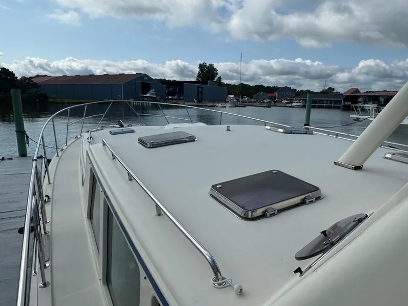 Slide: The Image of 2003 Dettling 51 Express Cruiser docked at marina under cloudy sky. - 14