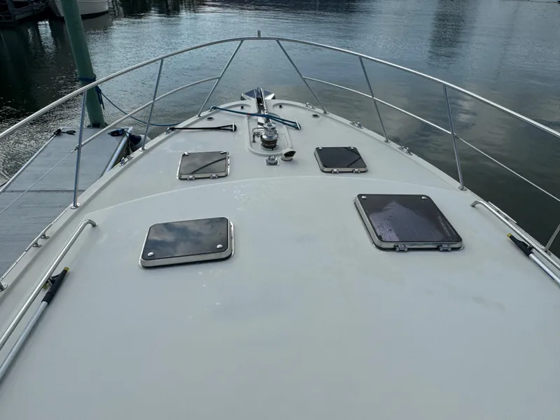 Slide: The Image of 2003 Dettling 51 Express Cruiser bow view with hatches and railing. - 15